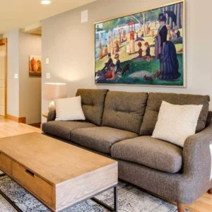 Georges Seurat painting reproductions displayed in a living room – A Sunday on La Grande Jatte replica