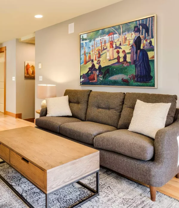 Georges Seurat painting reproductions displayed in a living room – A Sunday on La Grande Jatte replica